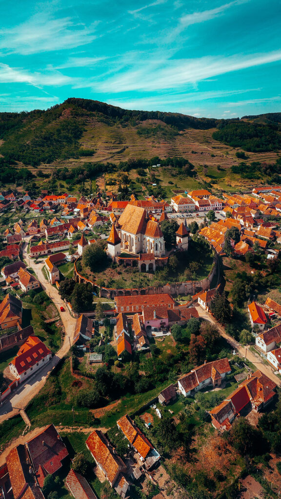 flygfoto av samhälle med kyrka och hus med röda tak